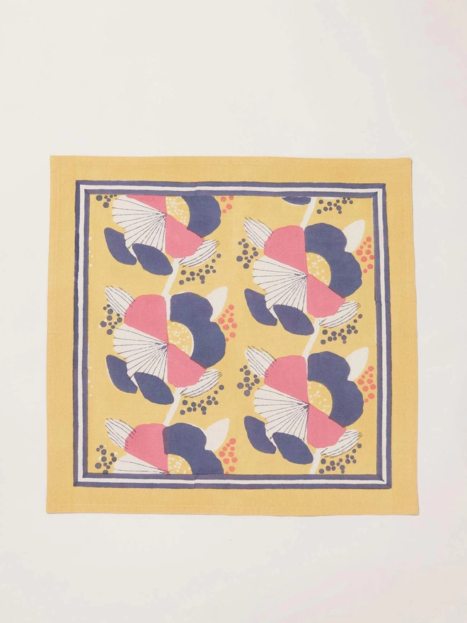 Single yellow block printed floral napkin with stripe border
