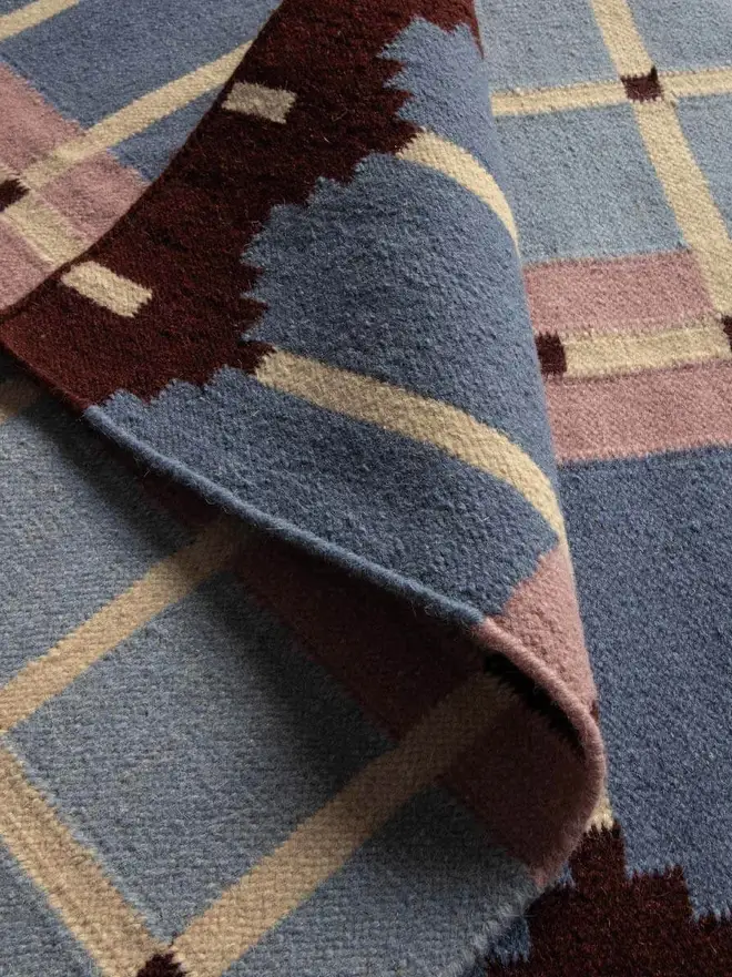 Corbie Flatweave Rug, a colourful rug sitting on a household floor. 