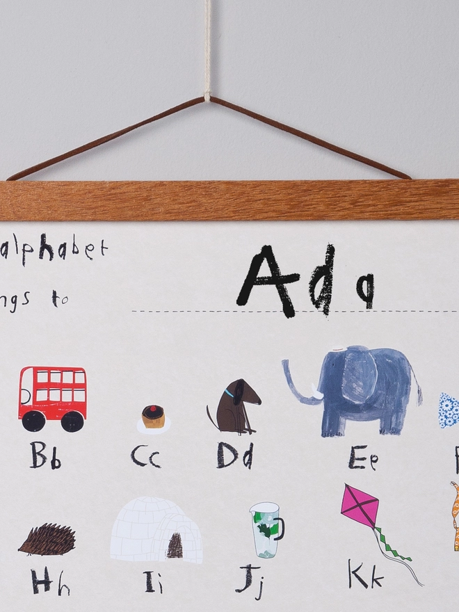 detail of alphabet poster with oak poster hanger, b for bus, d for dog