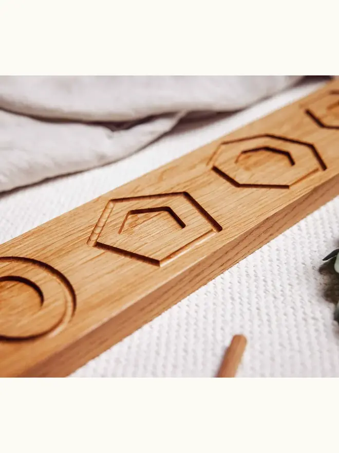 Wooden Shape Tracing Puzzle Heirloom Toy, on a table. 