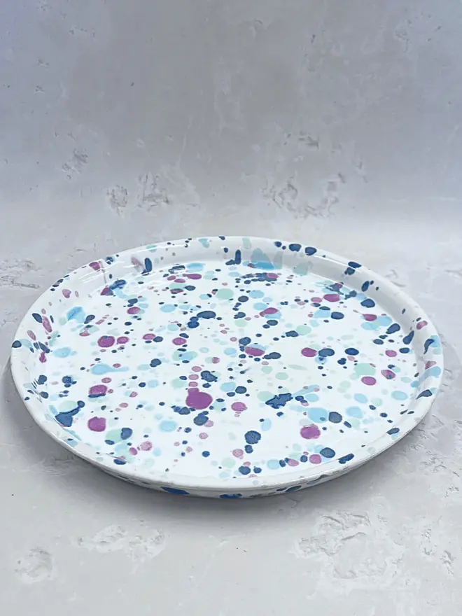 Sweetpea Dinner Plate, a colourful dinner plate placed on a stone surface.