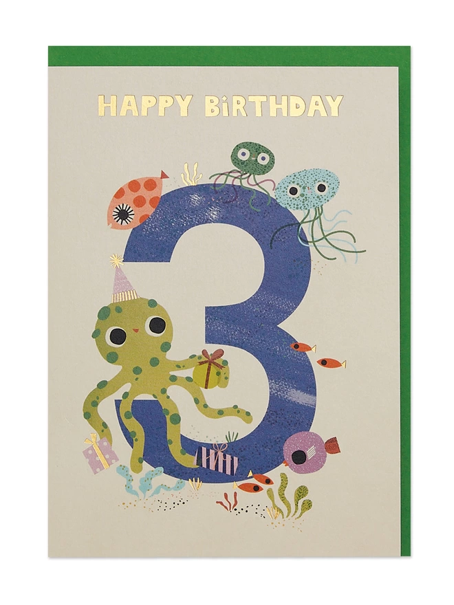 Enchanting underwater scene illustrations on an age 3 birthday card featuring jellyfish, octopus and a colourful array of fishes, all finished off with gold foil details and a ‘Happy Birthday’ message