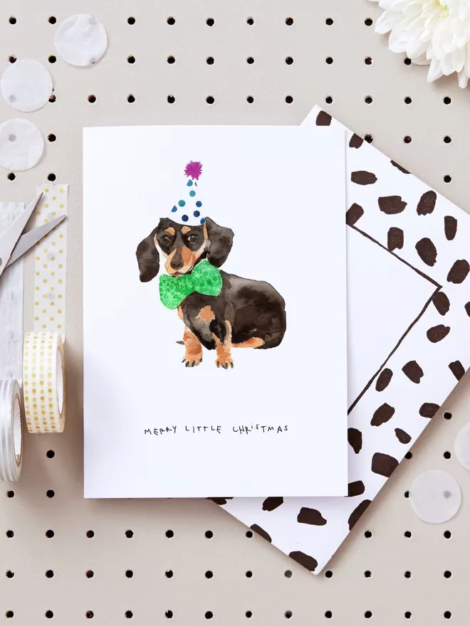 Blank Inside Merry Little Dachshund Christmas Card seen with a black and white spotted envelope.
