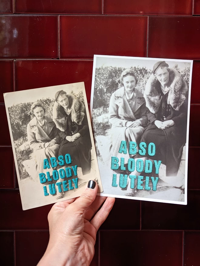 B&W photo of 2 women with Abso-bloody-lutely in teal embroidered across, print & original