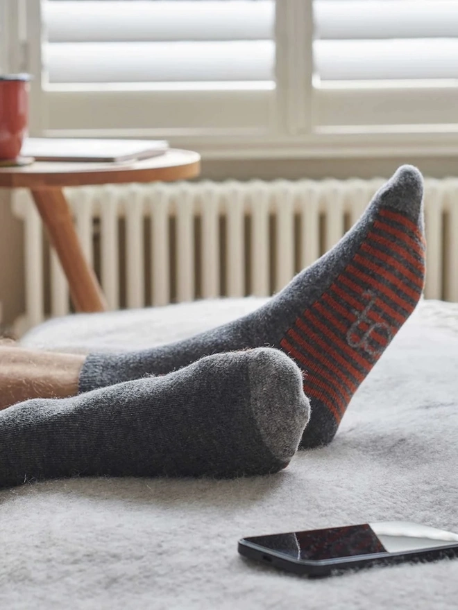 Men's Organic Cotten Striped Arch Ankle Socks, a man wearing a pair of colourful socks. 