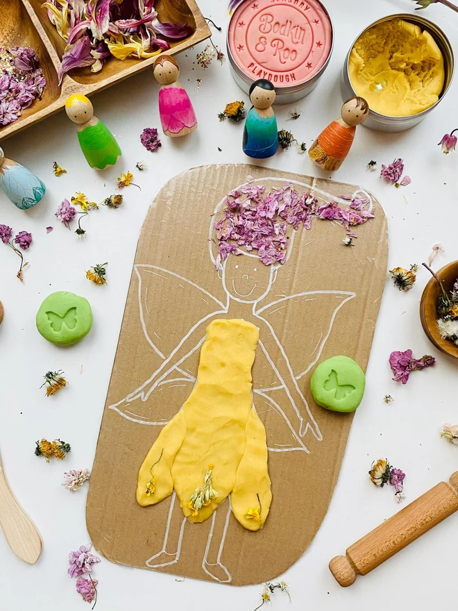 fairy sensory play dough sensory set. a cardboard fairy drawing with dough clothing. 