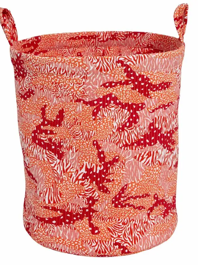 Orange Big Cat Camo Quilted Storage Basket, an orange storage basket sitting on a white surface against a plain background. 