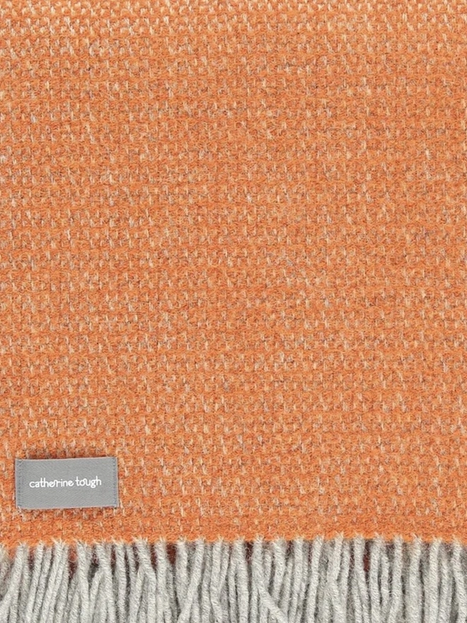 Organic Wool Throw, an organic wool throw folded on a white surface. 