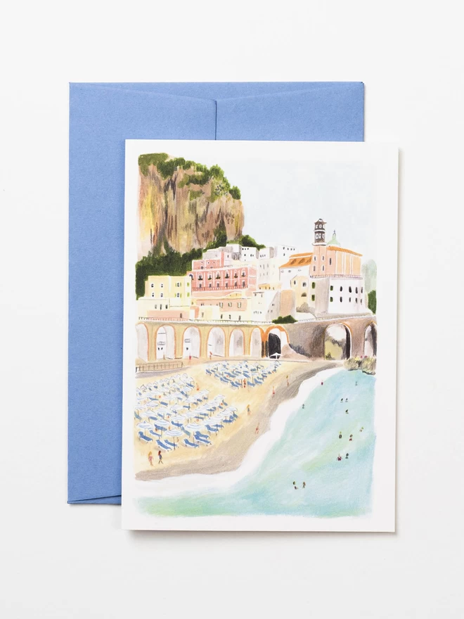 An illustrated greetings card, with corresponding pale blue envelope. The card features a pencil drawing of the beach and cliffs on the Amalfi coast, 