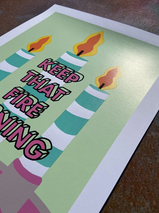 "Keep That Fire Burning" Hand Pulled Screen Print  depicting three candles in the back ground lit up with flames and the words keep that fire burning printed on top 