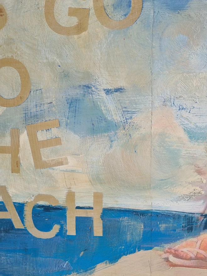 Upcycled art panel in blues and creams featuring a seascape and an image of a retro pin-up lady on a boat and the text reads ‘let’s go to the beach’ in a distressed, shabby chic style