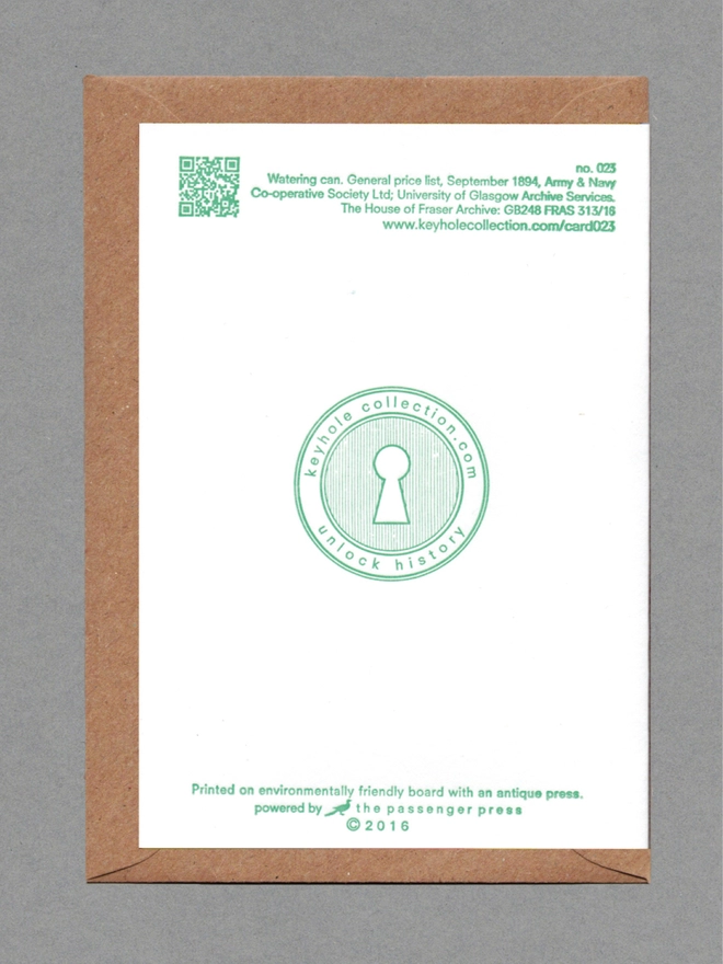 Back face of a white card on a brown envelope. Printed green text, logo and QR code.