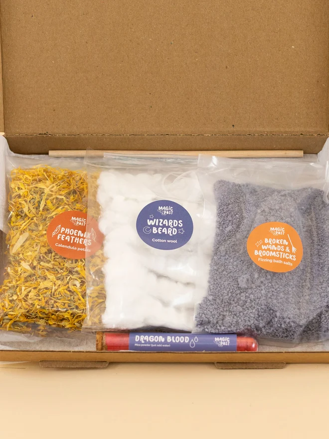 witches and wizards mini sensory potion kit. three bags of varied sensory ingredients placed into a cardboard box.