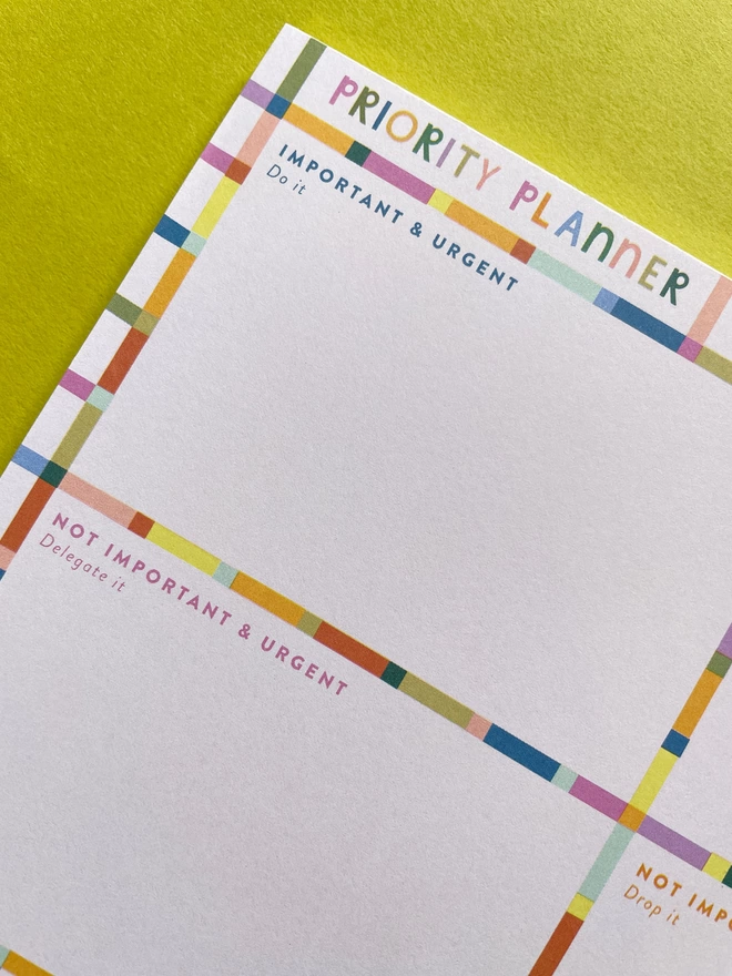 Close up of Raspberry Blossom ‘Priority planner’ tear-off pad with colourful grid design