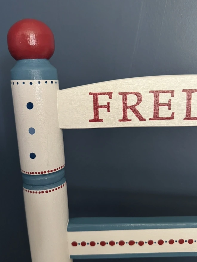 Personalised Childs wooden chair with red and blue detail. 