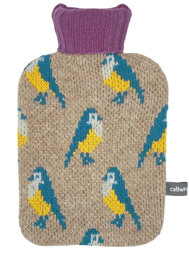Mini Lambswool Hot Water Bottle Cover, a mini water bottle sitting on a white plain surface. 