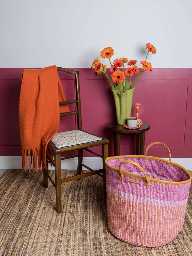 lifestyle showing pink, purple and orange sisal laundry basket