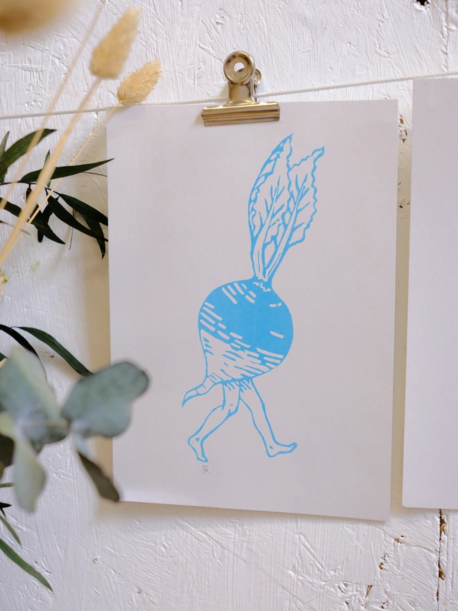 a blue radish with legs print on a white wall