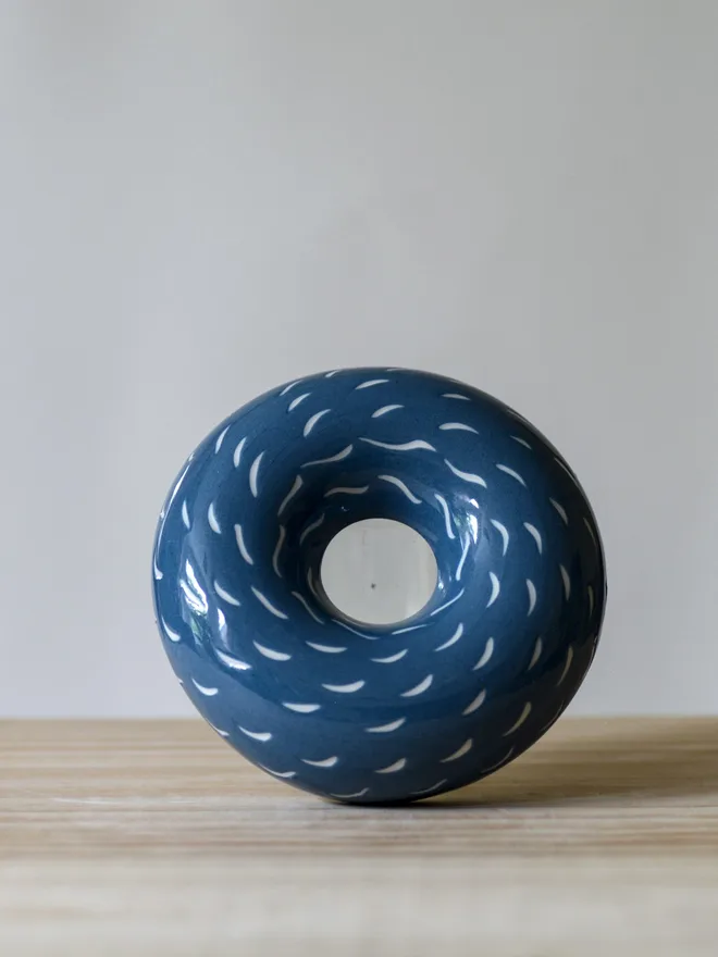 Handmade porcelain avocado planter with carved blue pattern, designed to hold an avocado seed for sprouting