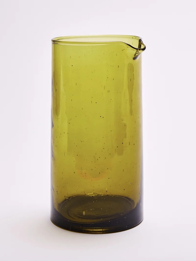 Glass Carafe, a large amber glass jug sitting against a plain backdrop. 