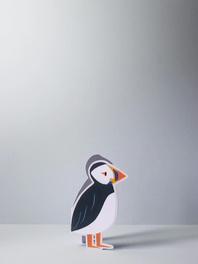 A cut out card of a puffin