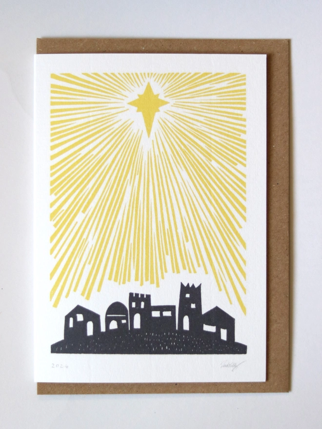 A Christmas card based on an original linocut design featuring Bethlehem and a star