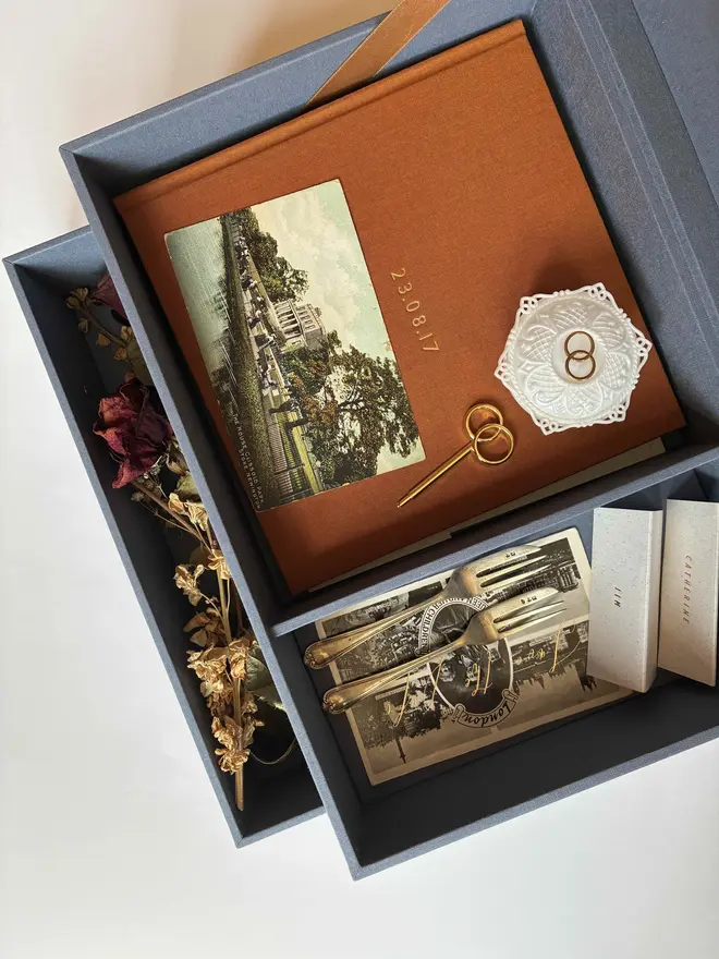 Open wedding keepsake box sowing divided top tier, open drawer, guestbook and wedding ephemera