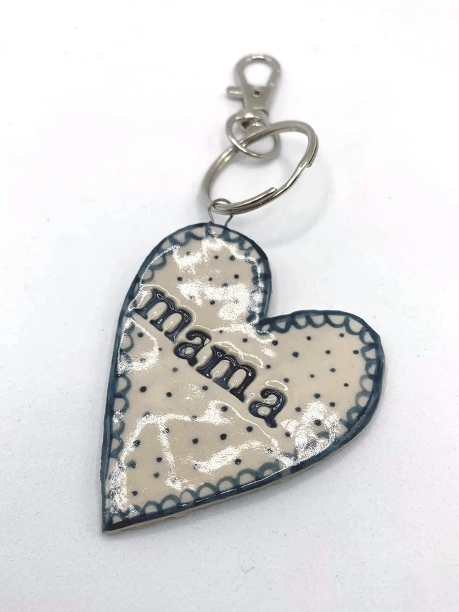 Mama Heart Ceramic Keyring, a blue keyring sitting on a plain white surface. 