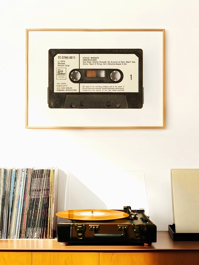 stevie wonder innervisions cassette tape print. framed print hung above record player and vinyl collcetion.