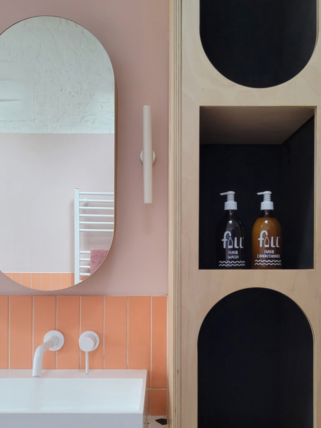 Hair Wash. A bottle of Hair Wash and Hair Conditioner on a bathroom shelf.
