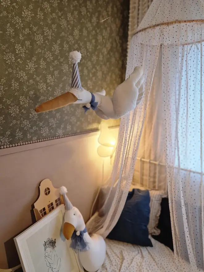 Circus Swan Hanging Decoration, a hanging swan decoration suspended in a child's bedroom. 