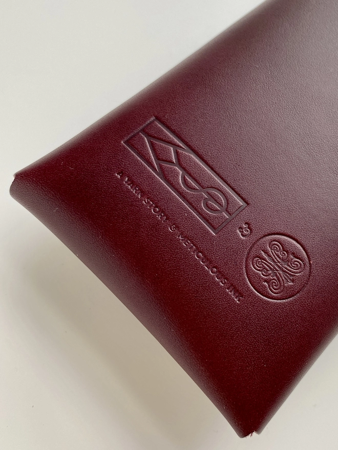 Meticulous Ink Leather Pencil Case - Close up of engraved logos on back of case