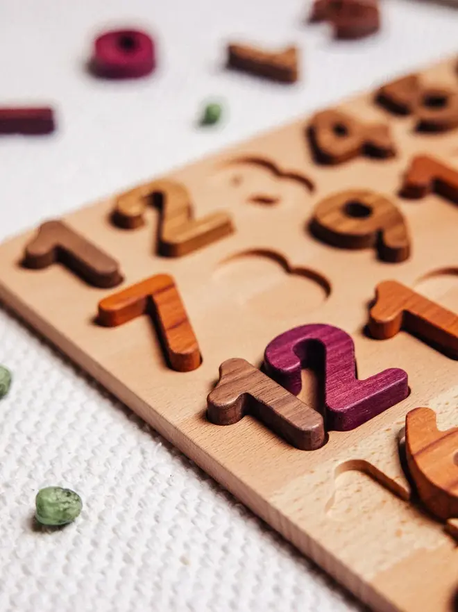 Extended Wooden Number Puzzle Heirloom Toy, on a table. 