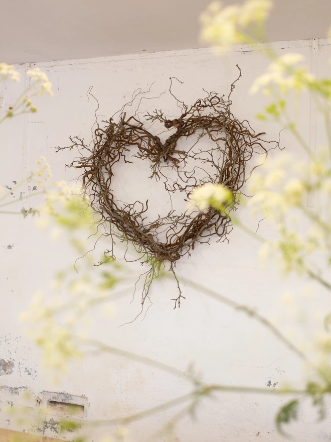 heart shaped wreath made from magnolia branches, hung on wall