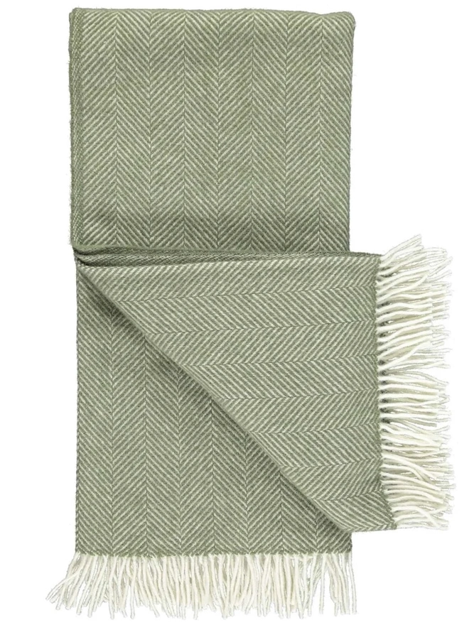 Organic Wool Throw, an organic wool throw folded on a white surface. 