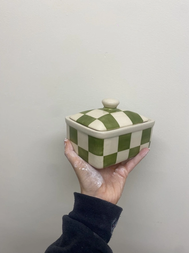  Checkered Green & Cream Handmade Ceramic Butter Dish, a green patterned butter dish held against a white backdrop. 
