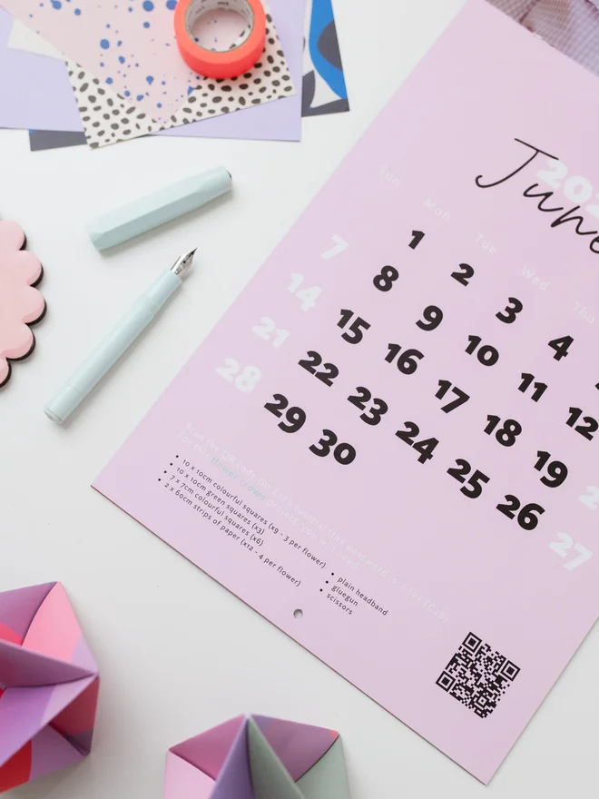 Example page of calendar open on table with craft materials surrounding.