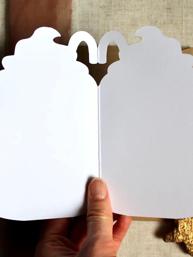 season's greetings christmas hot chocolate card. christmas card shaped like a mug opened to show blank inside.