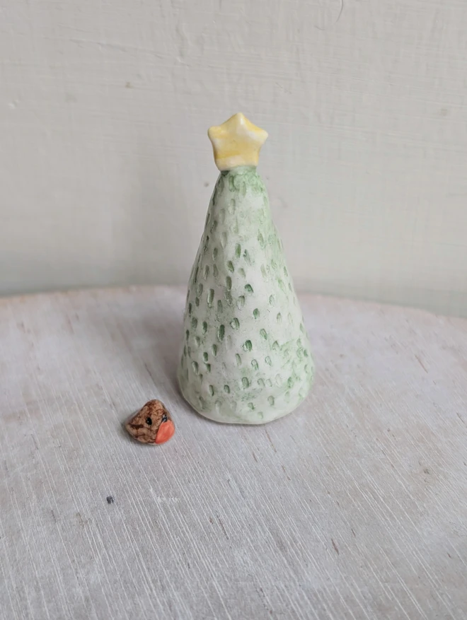 green ceramic christmas tree and tiny robin bird