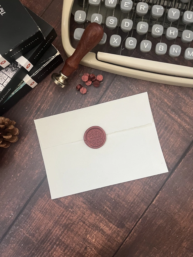 letter to santa, hand typed onto handmade cotton rag paper using an antique typewriter with a merry christmas red wax seal and envelope. 