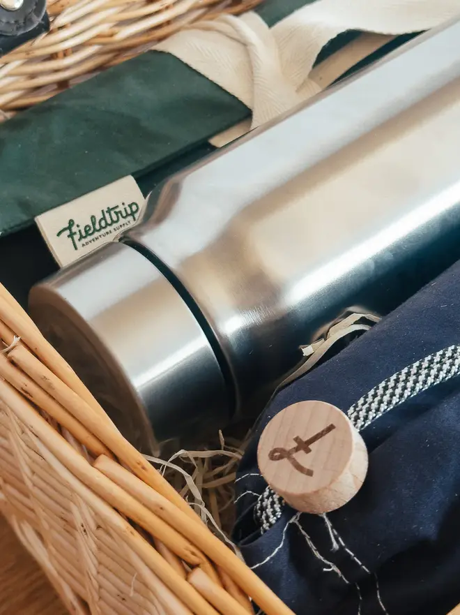 willow complete picnic hamper. a stainless steel flask inside a willow picnic basket.