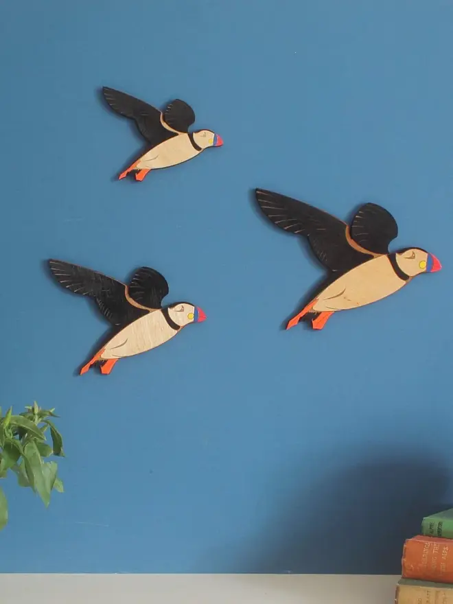 Flying Wooden Wall Puffins (Set Of 3), group of flying wooden puffins hanging on wall. 