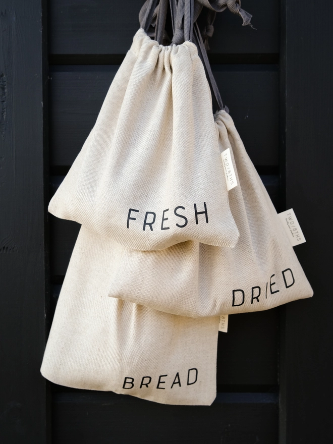 set of three linen refill bags hung from a hook