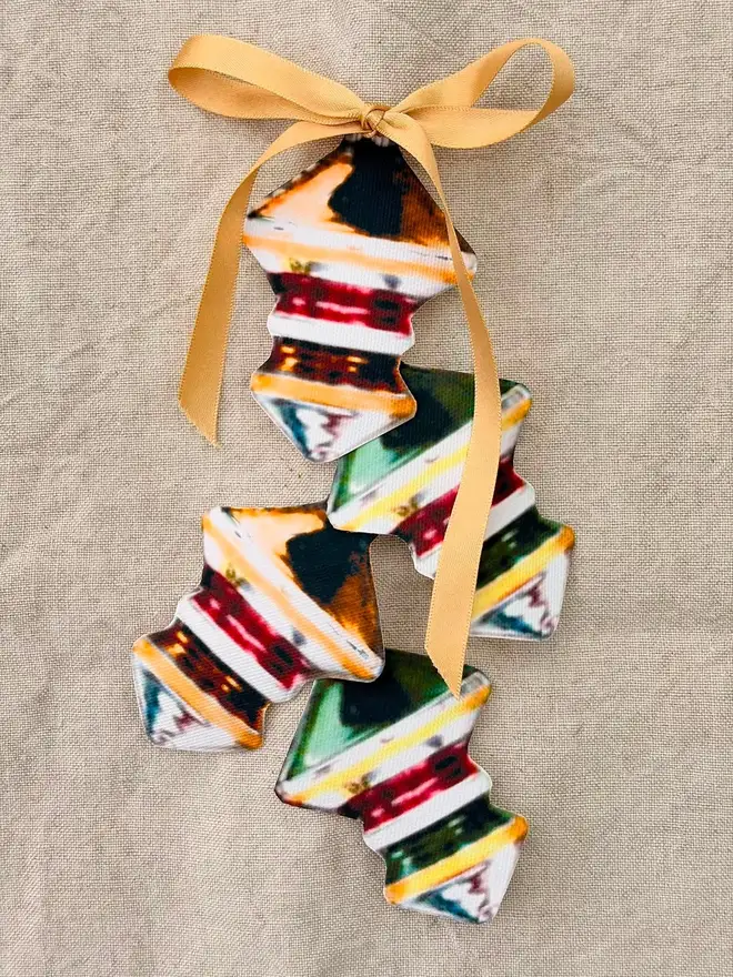 A set of four retro shaped cutouts on a linen tablecloth