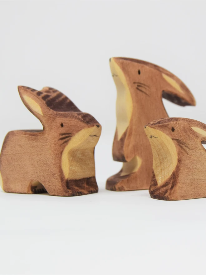 three wooden toy brown bunnies as a family set