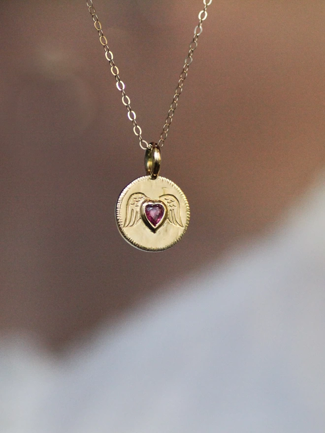 gold angel wing necklace with ruby