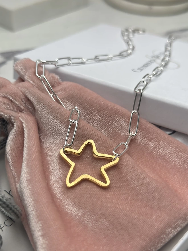 rough hewn open star charm in gold on a sterling silver paperclip chain with gift box and pouch