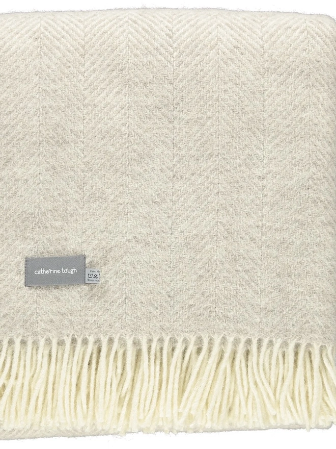 Organic Wool Throw, an organic wool throw folded on a white surface. 