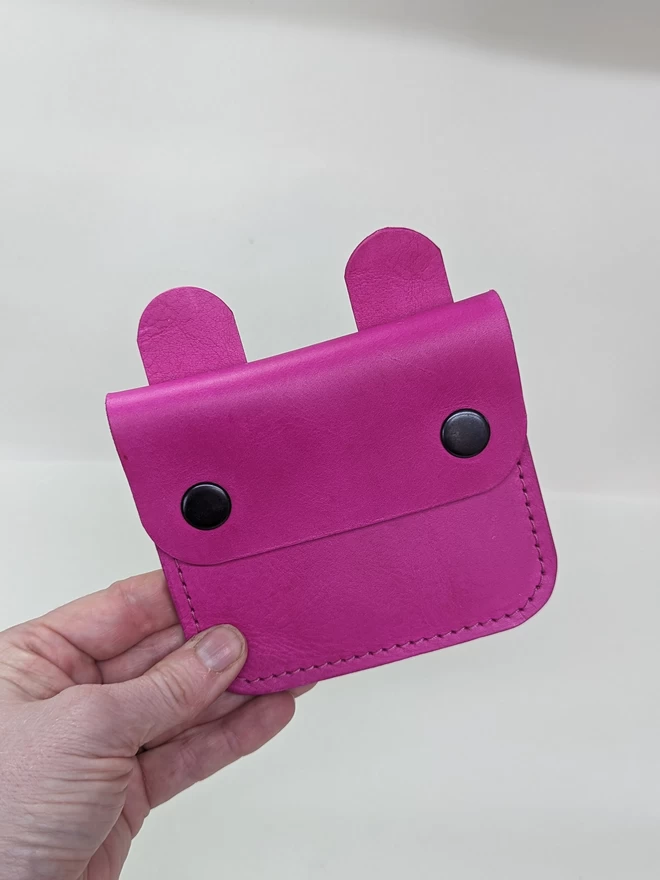 Front view of leather 'Tiny Wild' Bunny purse in fuchsia.