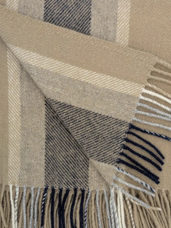 Organic Wool Throw, an organic wool throw folded on a white surface. 